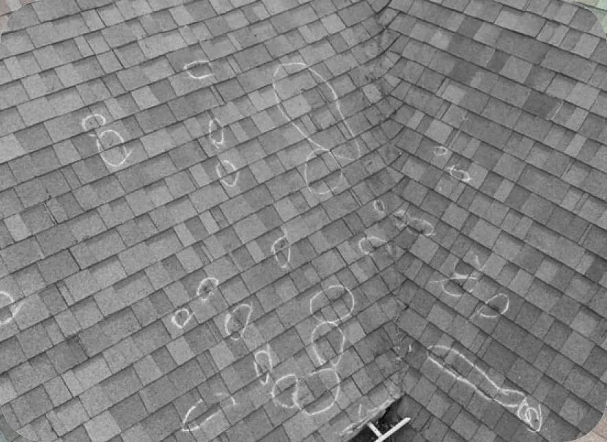 Professional roofer inspecting hail damage