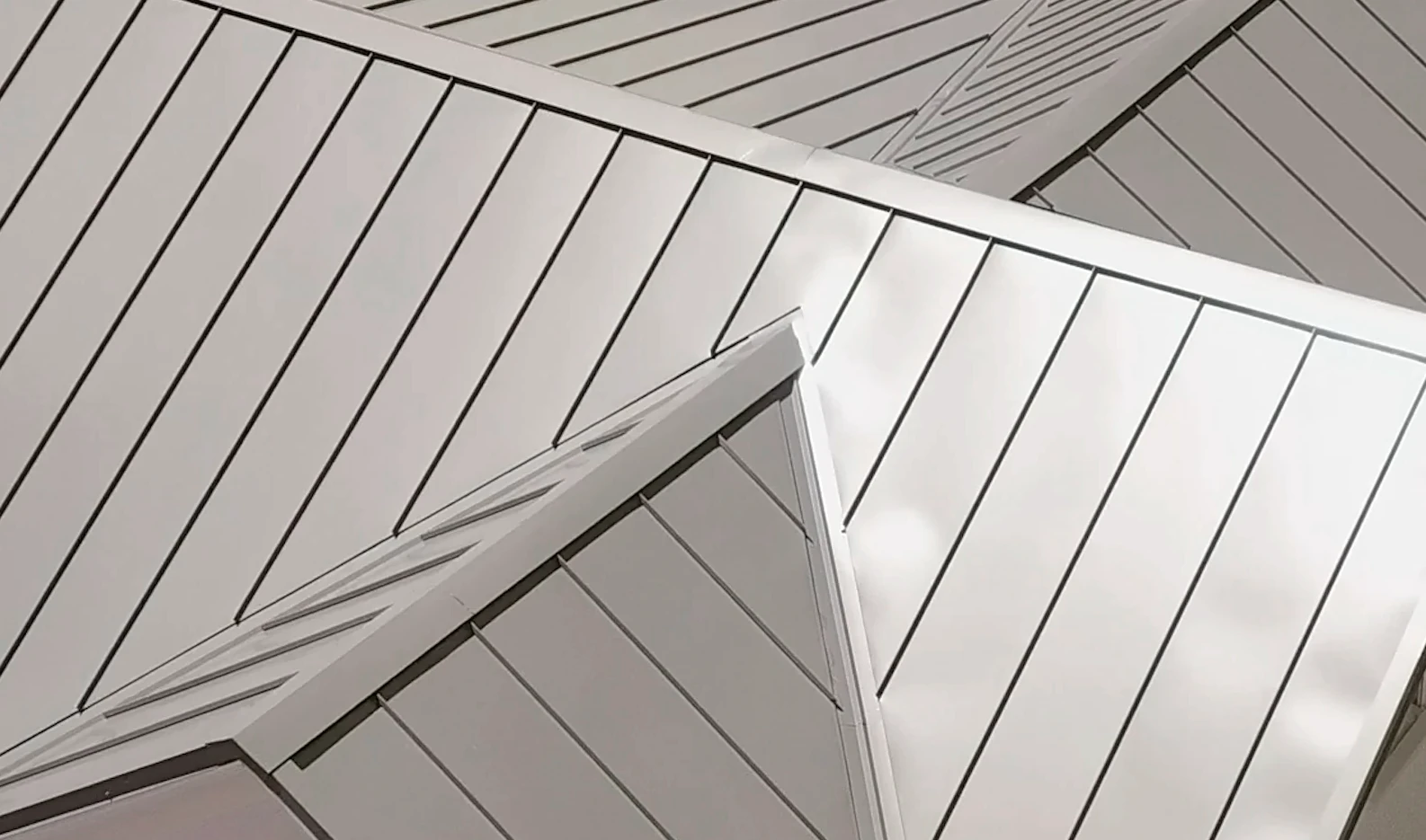 Close-up of standing seam metal roof showing clean lines and raised seams